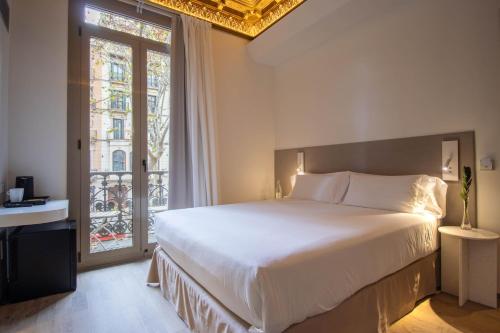 a bedroom with a large bed and a window at Storni Barcelona by Forget me not in Barcelona