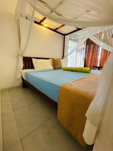 a bedroom with a bed in a room at Tango Sunrise Villa in Tangalle
