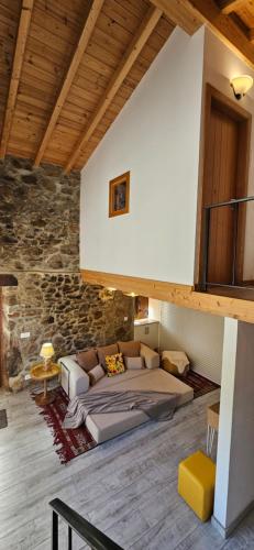 a bedroom with a bed and a couch in a building at Casa BelaVista Penela - Charming Guest House - Adults Only in Penela