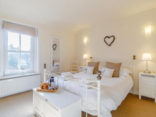 a white bedroom with a white bed and a window at 2 Bed in Holt oc-ncc11 in Holt