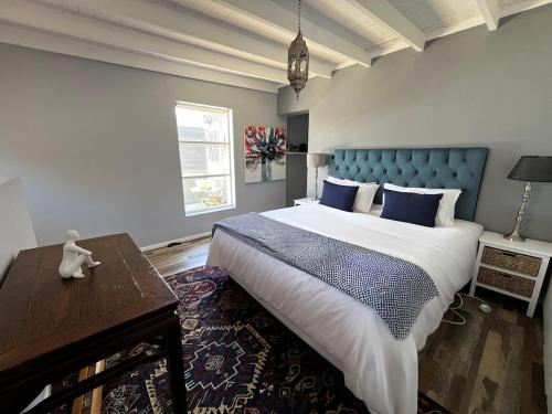 a bedroom with a large bed with a blue headboard at Derby in Lakeside