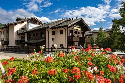 a house with flowers in front of it at Residence Nevegall by Original Galli in Livigno