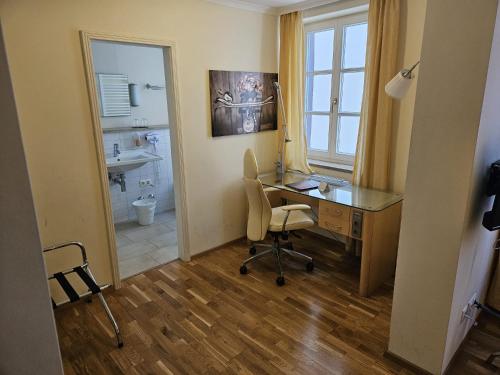 an office with a desk and a chair and a sink at Hotel Rose in Weißenburg in Bayern