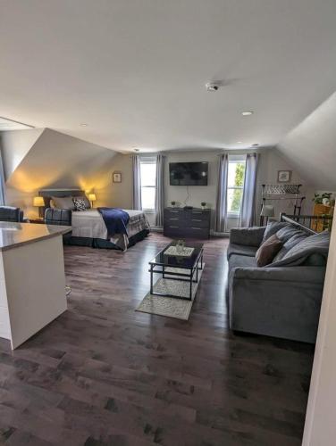 a living room with a couch and a bed at Dominion Place Studio in Moncton