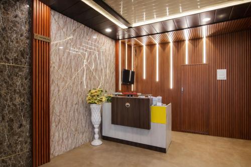 a lobby with a reception desk and a television at Hotel Vijay Palace Dharamshala Himachal in Dharmsāla