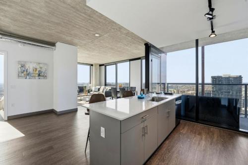 an open kitchen with a view of a city at 2BR Designer Loft Modern Luxe in City Center in Chicago