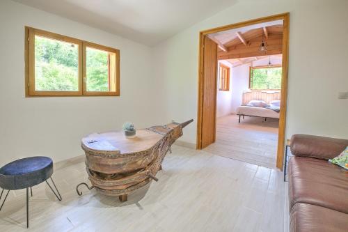 a living room with a wooden table and a couch at Le chalet sur Manoire in Saint-Laurent-sur-Manoire