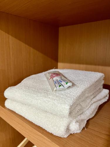 a pile of towels sitting on top of a table at Aurora Hotel Siliwangi in Cirebon