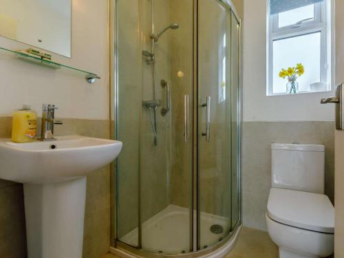 a bathroom with a shower and a sink and a toilet at 3 Bed in Bridport oc-dc117 in West Bay