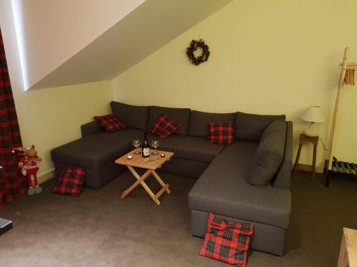 a living room with a couch and a table at New Gudauri GoodHost Apartments in Gudauri