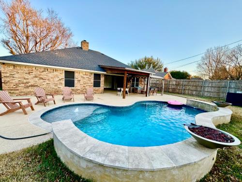 a swimming pool in the yard of a house at Keller Charm-Near Bear Creek Park & Stadiums,Pool in Keller