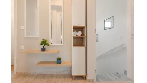 a room with a white closet with shelves and a door at Ruvelis private pool villa in Fiolítis