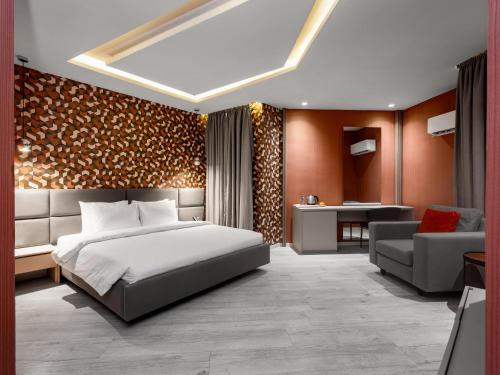a bedroom with a bed and a living room at Atlanticblu hotels & Resort in Abuja