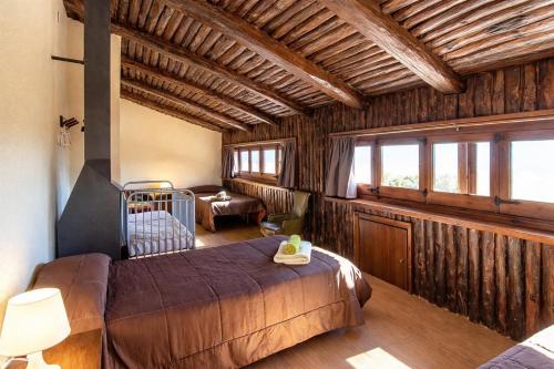 a bedroom with a large bed in a room with windows at Catalunya Casas Nature and Tranquility for 24 pax - 30km to beach in Sant Pere de Vilamajor