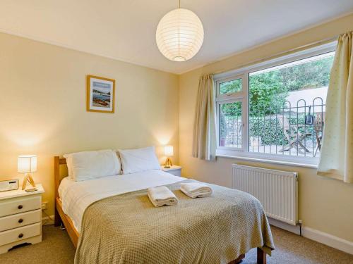 a bedroom with a bed and a large window at 3 Bed in Carnforth oc-sz425 in Arnside