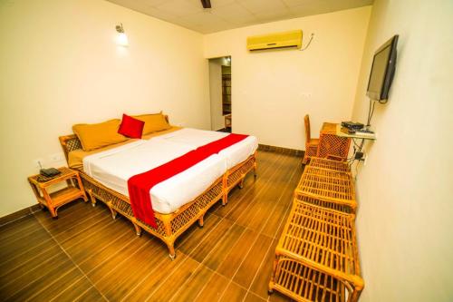 a bedroom with a bed and a television in it at Sharmada Hidden Nest Resort in Jāmb