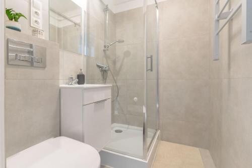 a bathroom with a shower and a toilet and a sink at Quiet Kraków Nest by Siemaszki 41 in Krakow