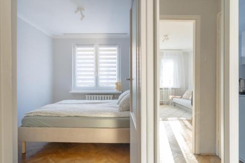 a bedroom with a bed and a window at Quiet Kraków Nest by Siemaszki 41 in Krakow