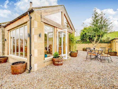 a cottage with a patio with a table and chairs at 2 Bed in Morpeth oc-88270 in Rothbury