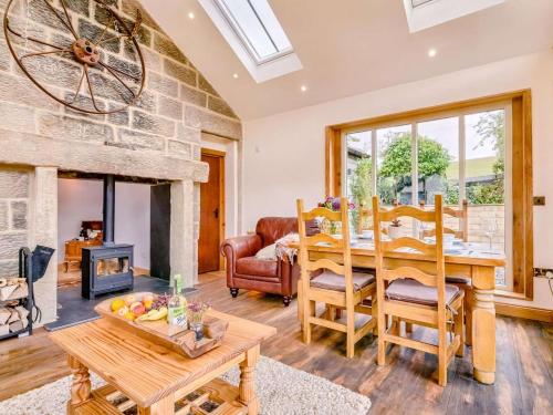a living room with a table and a fireplace at 2 Bed in Morpeth oc-88270 in Rothbury