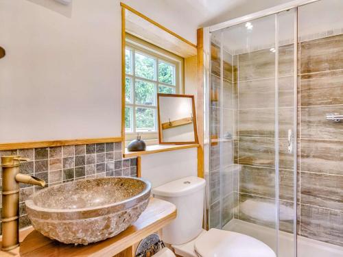 a bathroom with a stone sink and a shower at 2 Bed in Morpeth oc-88270 in Rothbury