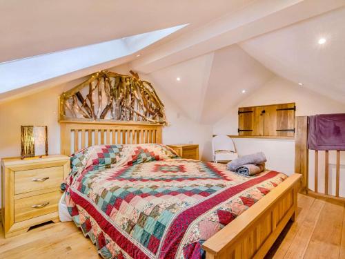 a bedroom with a large bed and a wooden dresser at 2 Bed in Morpeth oc-88270 in Rothbury