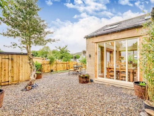 a wooden shed with a table and a tree at 2 Bed in Morpeth oc-88270 in Rothbury
