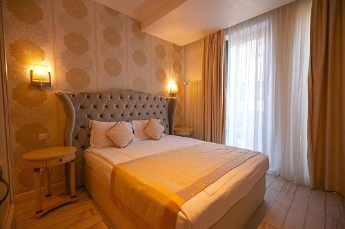 a hotel room with a bed and a window at Old Town Boutique Hotel in Bucharest