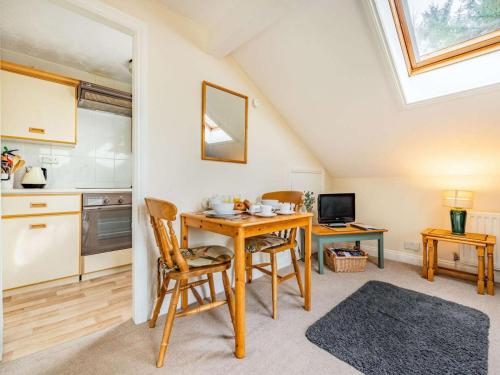 a kitchen and dining room with a table and chairs at 1 Bed in Penrith oc-sz295 in Dockray