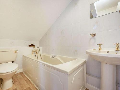 a white bathroom with a toilet and a sink at 1 Bed in Penrith oc-sz295 in Dockray