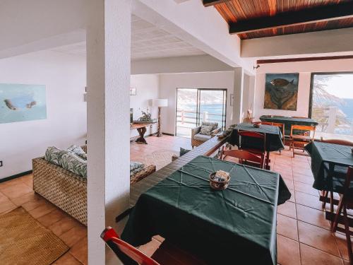 a living room with a table and a pool table at Mar Infinito Guest House in Arraial do Cabo