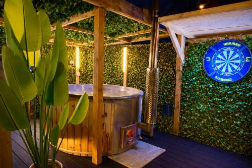 a jacuzzi tub on a deck with a sign at The Secret Garden Glamping Lancashire in Skelmersdale