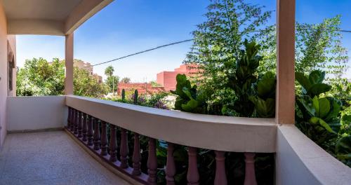 a balcony with a view of plants and buildings at peaceful apartment in Taroudant