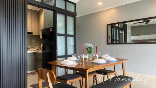 a dining room table with chairs and a mirror at Retro Game - D'Lagoon Sri Austin By iH Home in Kempas