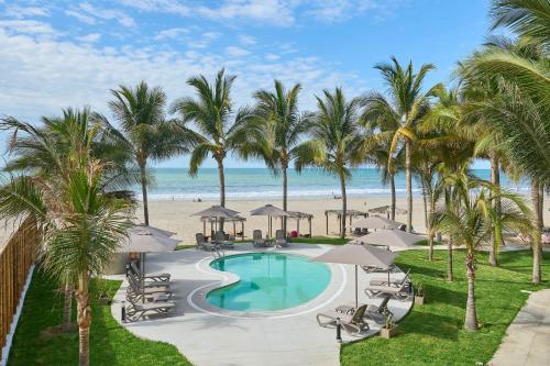 a view of a pool and the beach at Casa Andina Select Zorritos Tumbes in Zorritos