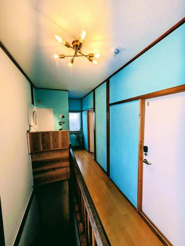 a hallway in a house with a ceiling fan at Kaido Urasa CoLiving in Minami Uonuma
