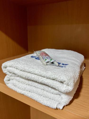a pile of towels sitting on top of a table at Aurora Hotel Kartini in Cirebon