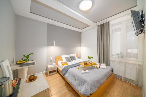 a bedroom with a bed and a table in it at S12 Boutique Residence - by Hosty in Krakow