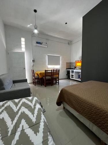 a room with two beds and a dining room with a table at Viva apart in Fiambalá