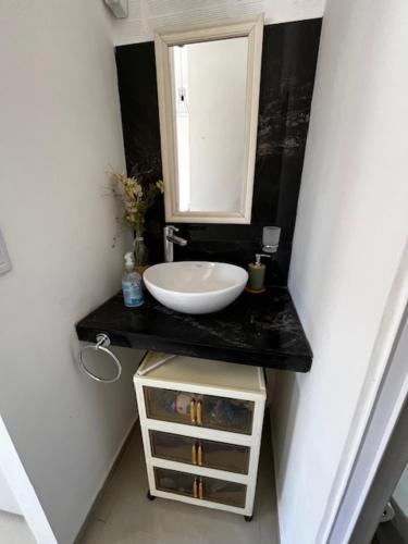 a bathroom with a sink and a mirror at Viva apart in Fiambalá