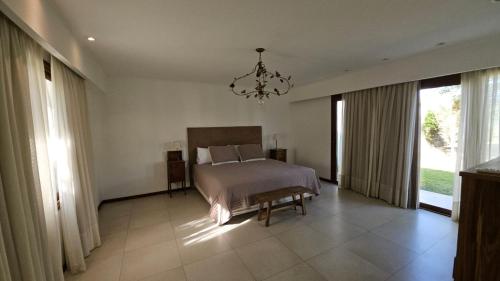 a bedroom with a bed and a chandelier at Casa Clara in Rufino
