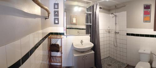 a white bathroom with a sink and a toilet at Gîte de la Gagée in Besmont