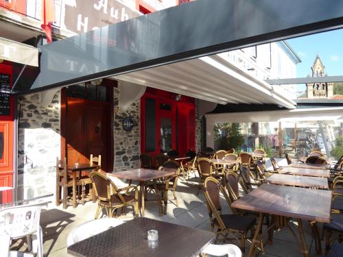 a group of tables and chairs on a patio at Auberge l'Escaleta in Seix