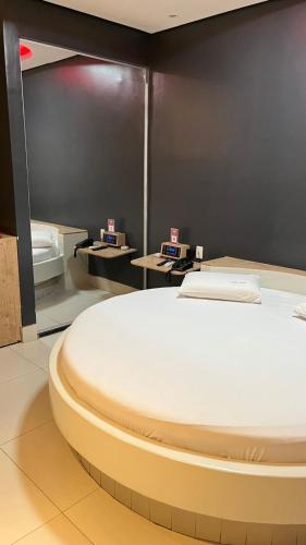 a room with a bed in the middle of it at Luxu's Motel in Tucano