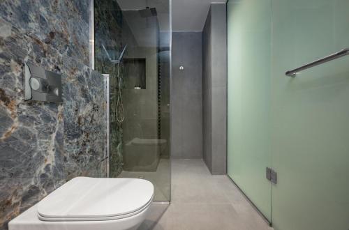 a bathroom with a toilet and a shower at Atlanticblu hotels & Resort in Abuja