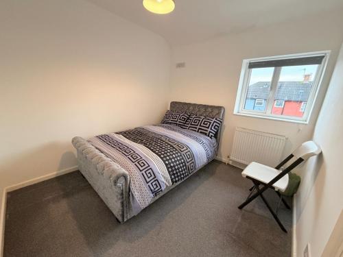 a small bedroom with a bed and a window at Precious House 5 in Leicester
