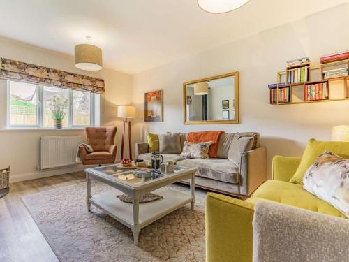 a living room with a couch and a table at 3 Bed in Penrith oc-86724 in Hackthorpe