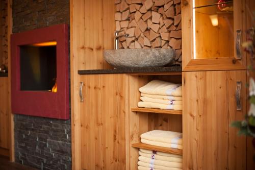 a bathroom with a sink and a shelf with towels at Ferien Bauernhof Maurachhof in Sankt Johann im Pongau