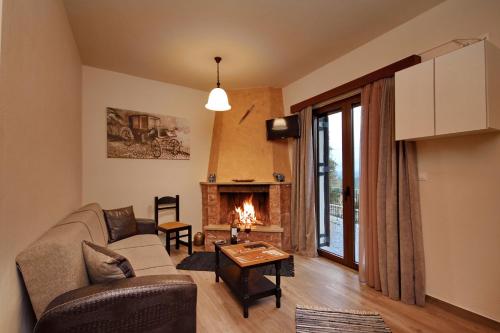 a living room with a couch and a fireplace at Valtessiniko Studios in Valtessiniko