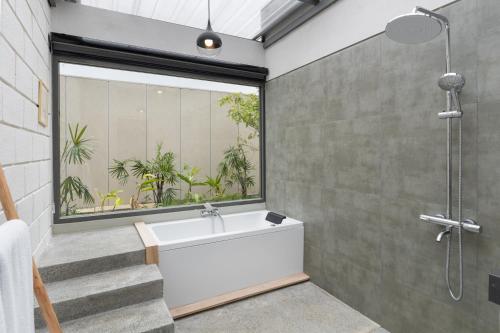 a bathroom with a shower and a bath tub at Chaparrals Surf in Dickwella